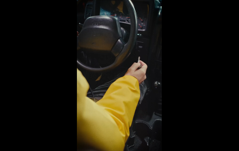 Extracted frame from the Jurassic Park Jeep teaser showing the interior and ignition key