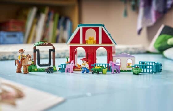 A LEGO® ǀ Disney and Pixar Toy Story 5 Blaze’s Horse Ranch featuring minifigures and accessories displayed on the floor.