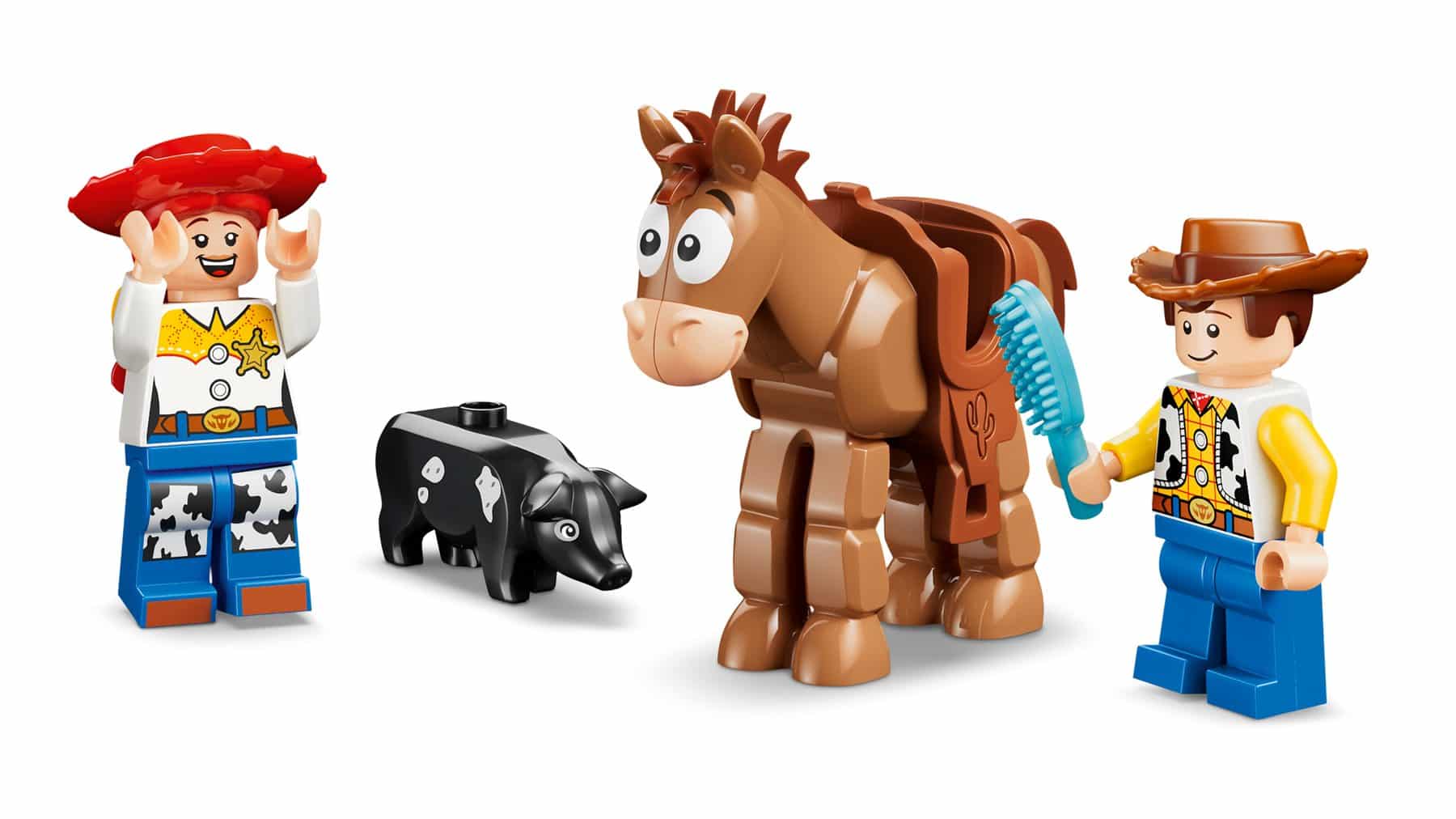 A line-up of minifigures and figures: Jessie, Blaze's pet pig, Bullseye the horse and Woody holding a horse brush.