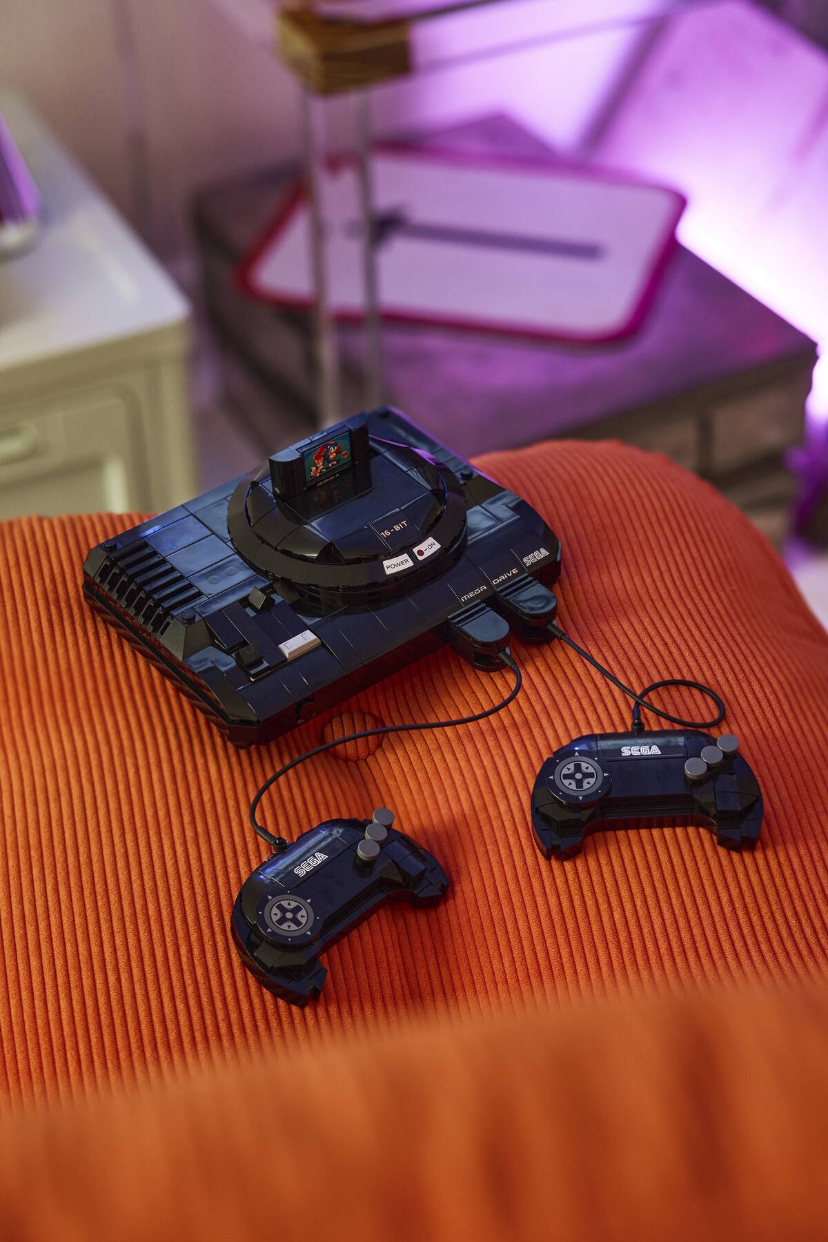 Official LEGO image of LEGO 40926 SEGA Genesis Console displayed in a gaming setup