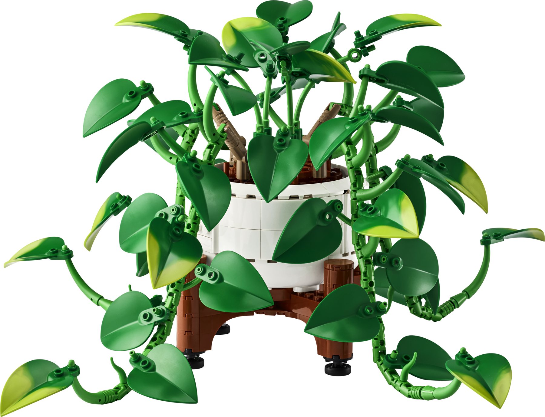 A LEGO® Botanicals Hanging Golden Pothos set with 4 vines displayed on a table, soft decor and plants in the background.