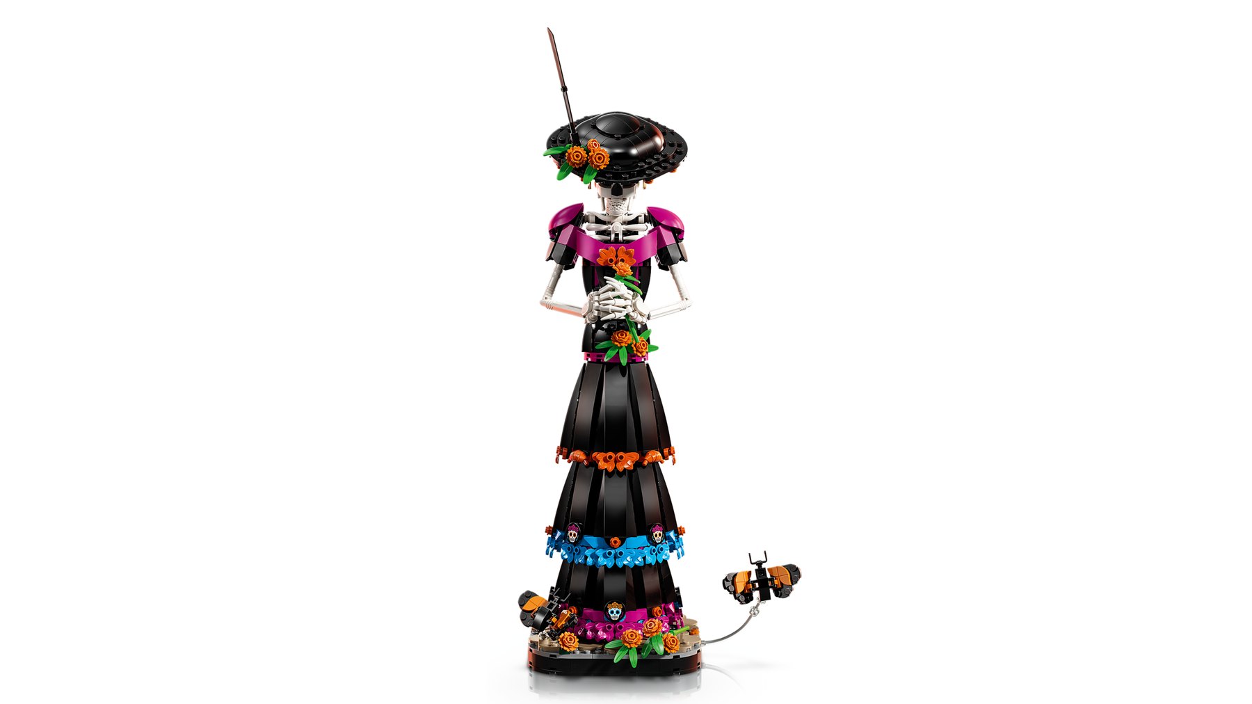 LEGO® Ideas La Catrina set showing a figure with a bowed head and clasped hands on a base decorated with flowers.