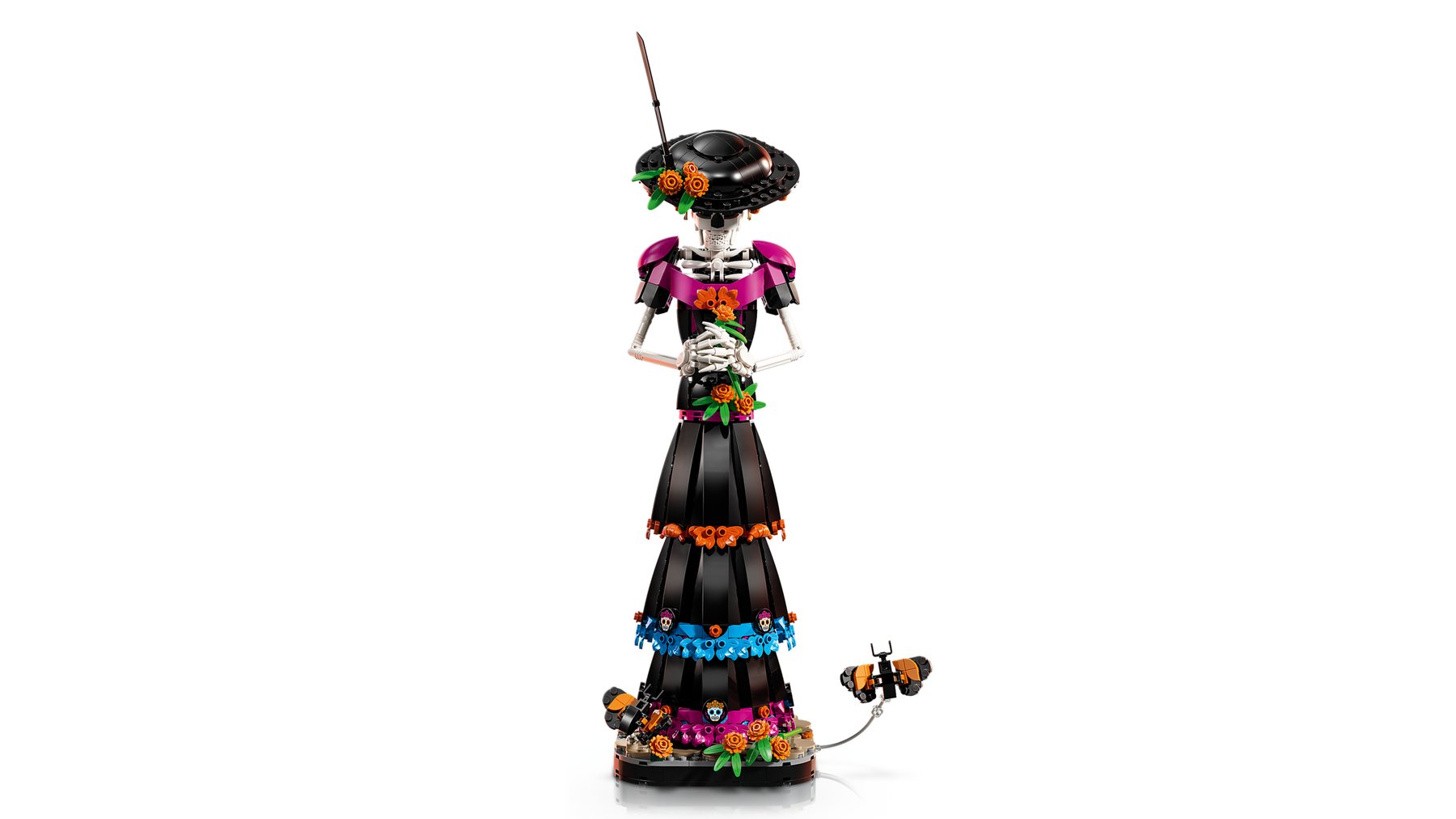 LEGO® Ideas La Catrina set showing a figure with a bowed head and clasped hands on a base decorated with flowers.