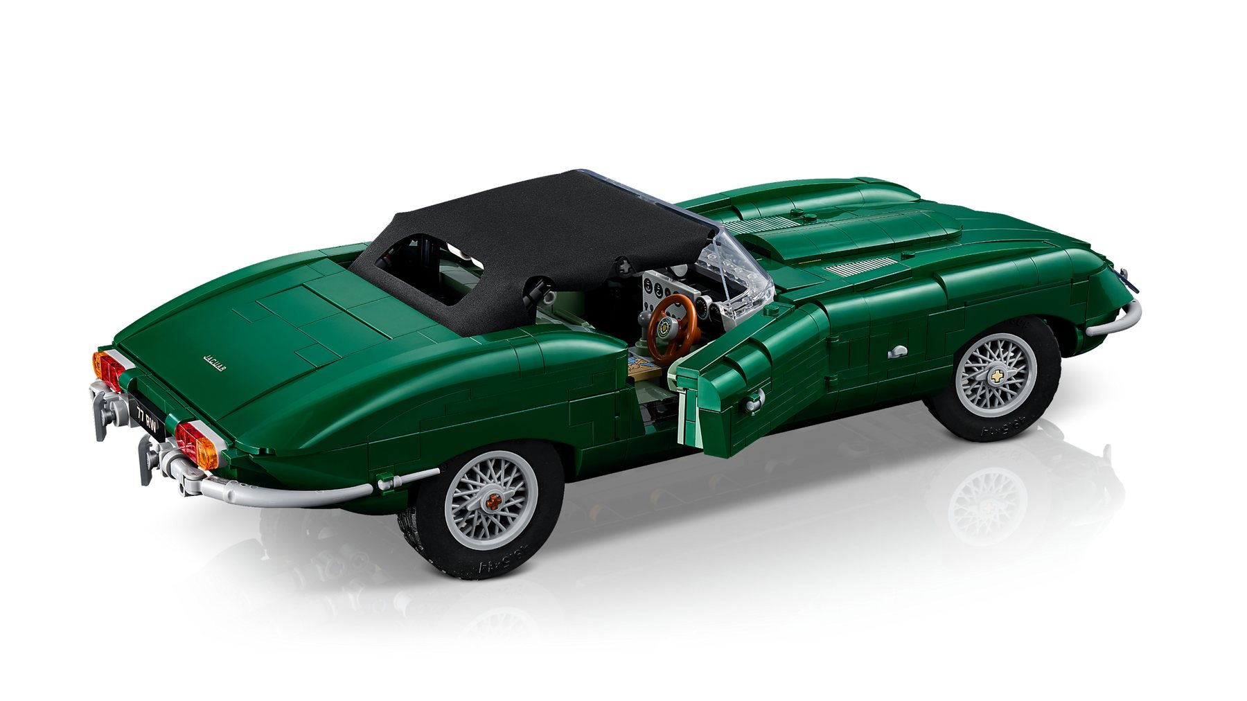 Side view of a LEGO® Icons Jaguar E-Type set with a closed roof and open doors revealing the cockpit.
