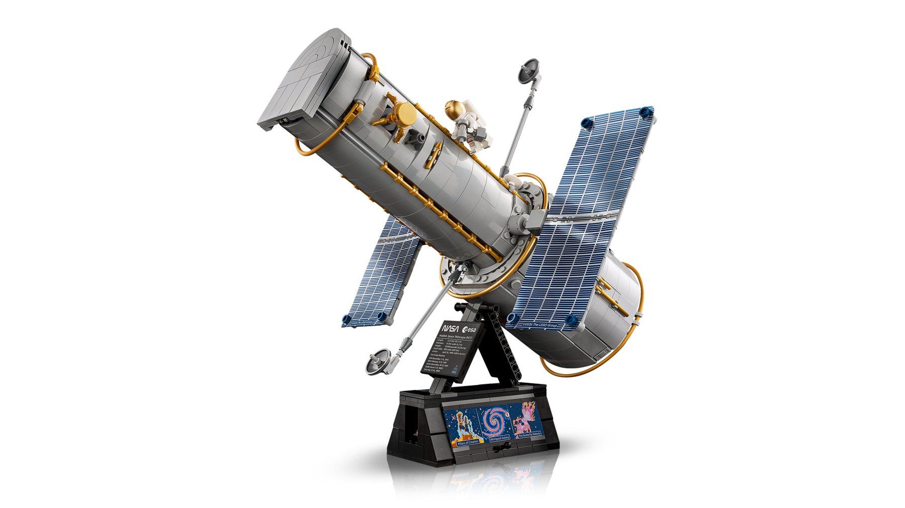 LEGO® Icons Hubble Space Telescope set on a stand featuring solar arrays and antennas, and an astronaut minifigure.