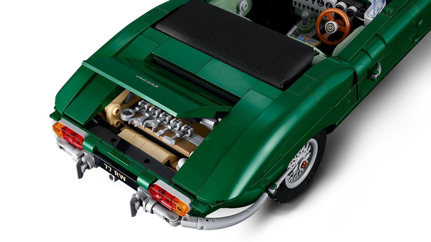 Close-up of the trunk in a LEGO® Icons Jaguar E-Type set showing the 5-piece tool kit stored inside.