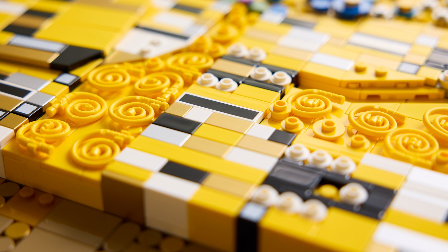 Close up of small elements, including spirals and studs, within the LEGO® Art Gustav Klimt – The Kiss artwork.