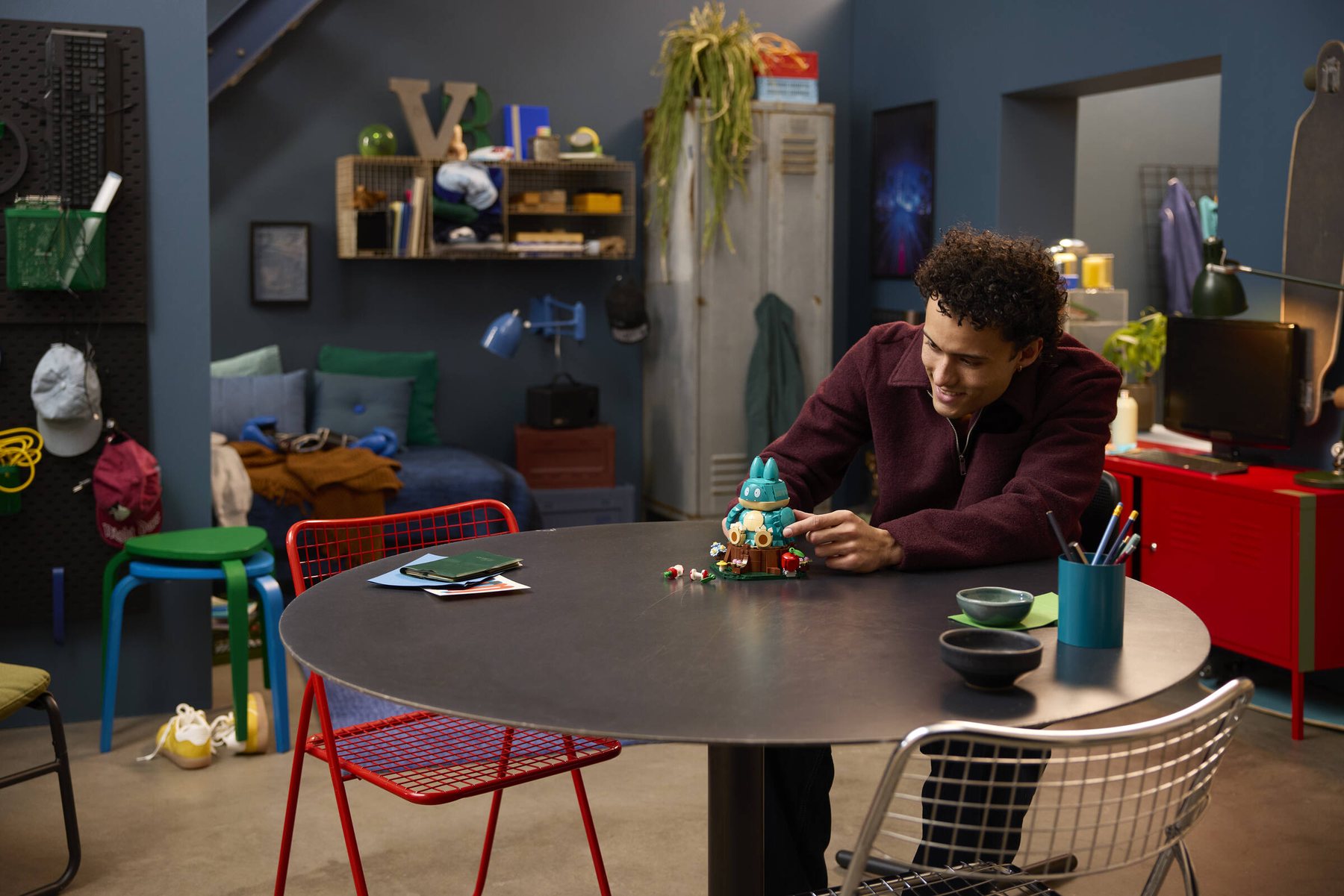 Boy at a table adjusting a built LEGO® Pokémon™ Munchlax.