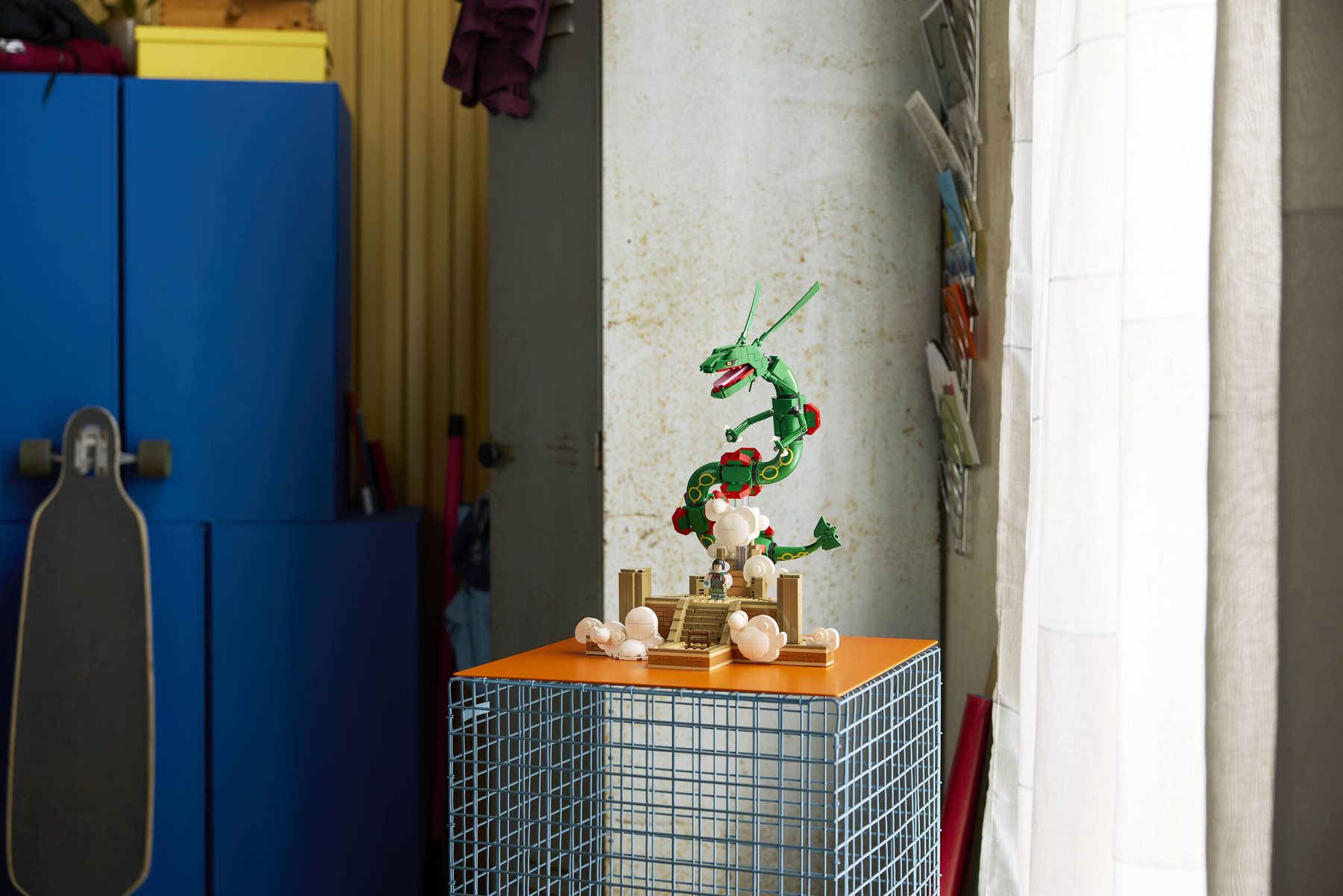 Built LEGO® Pokémon™ Rayquaza displayed on top of an orange metal shelving unit.
