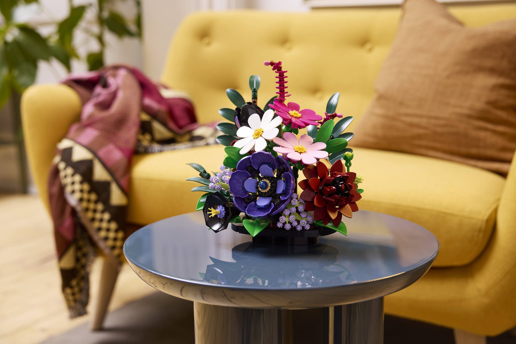 A LEGO® Botanicals Dark Flower Arrangement set displayed on a side table.