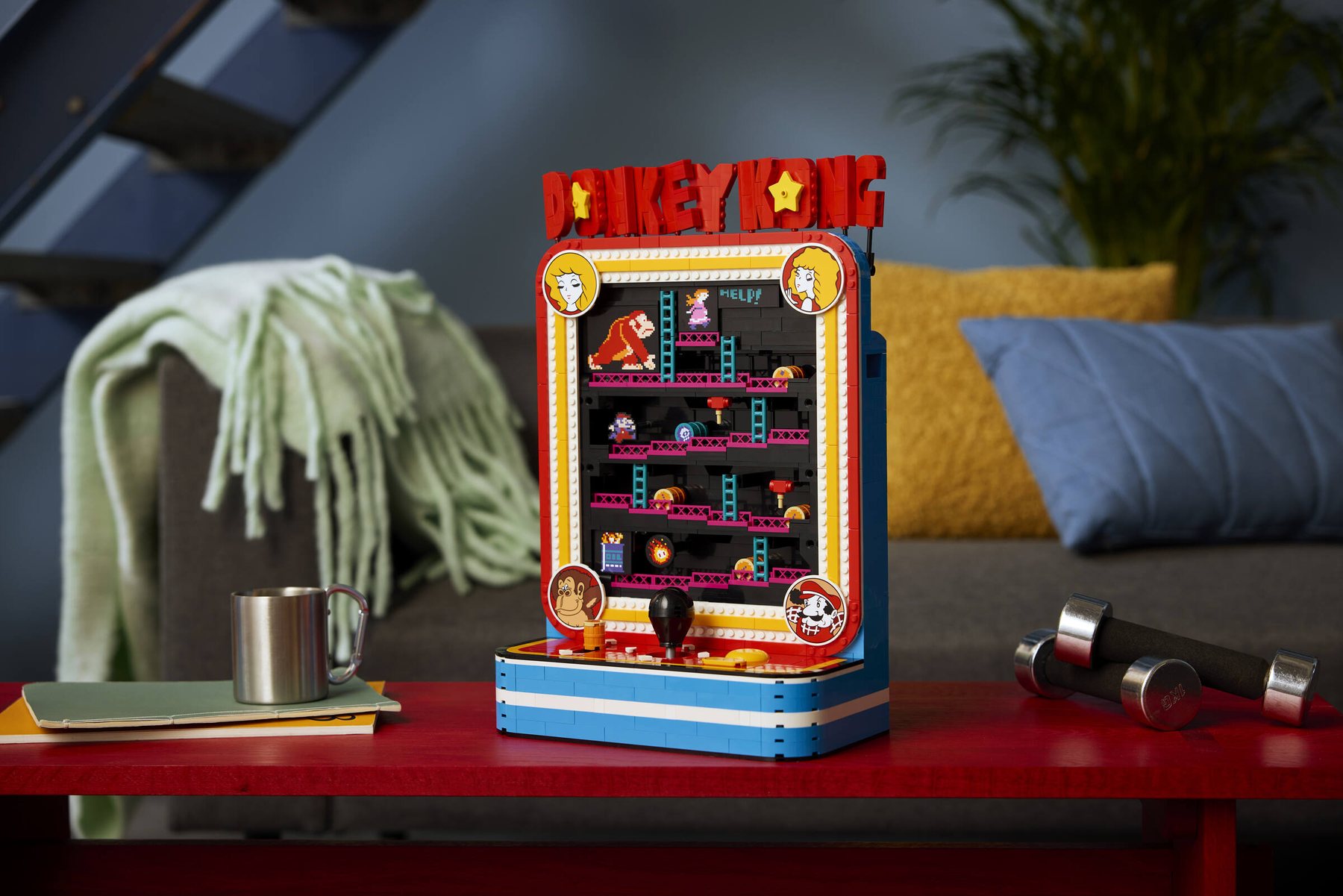 LEGO® Donkey Kong™ Arcade set displayed on a sideboard, next to a pile of books.