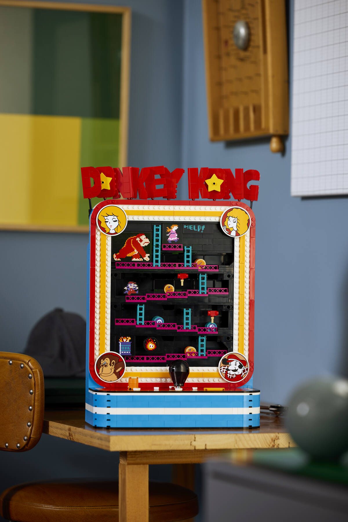 LEGO® Donkey Kong™ Arcade set displayed on a table, next to a leather office chair.